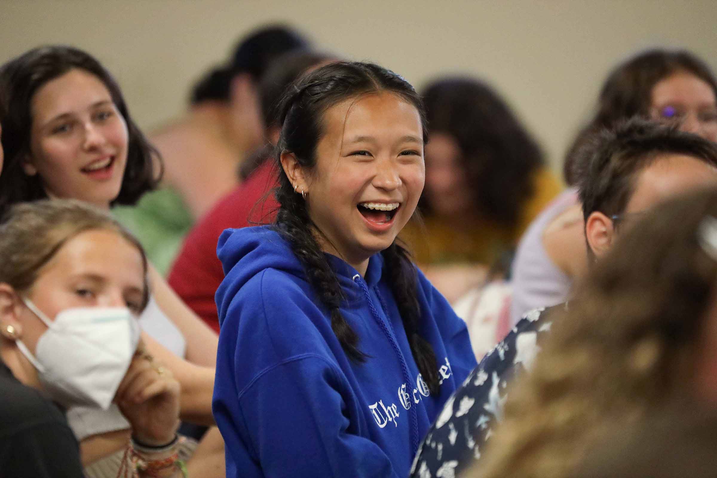 A camper laughs at an improv show